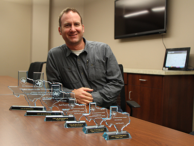 Multimedia Specialist Brian Ligon with the City's six 2014 TATOA awards.